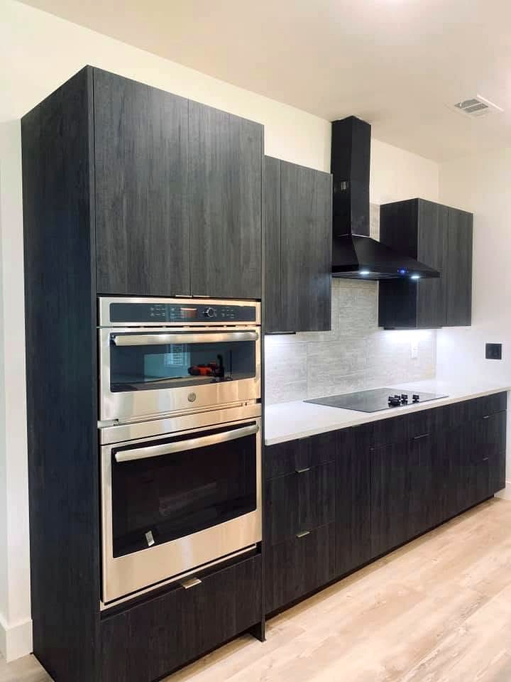 Frameless charcoal oak kitchen cabinets with double wall ovens