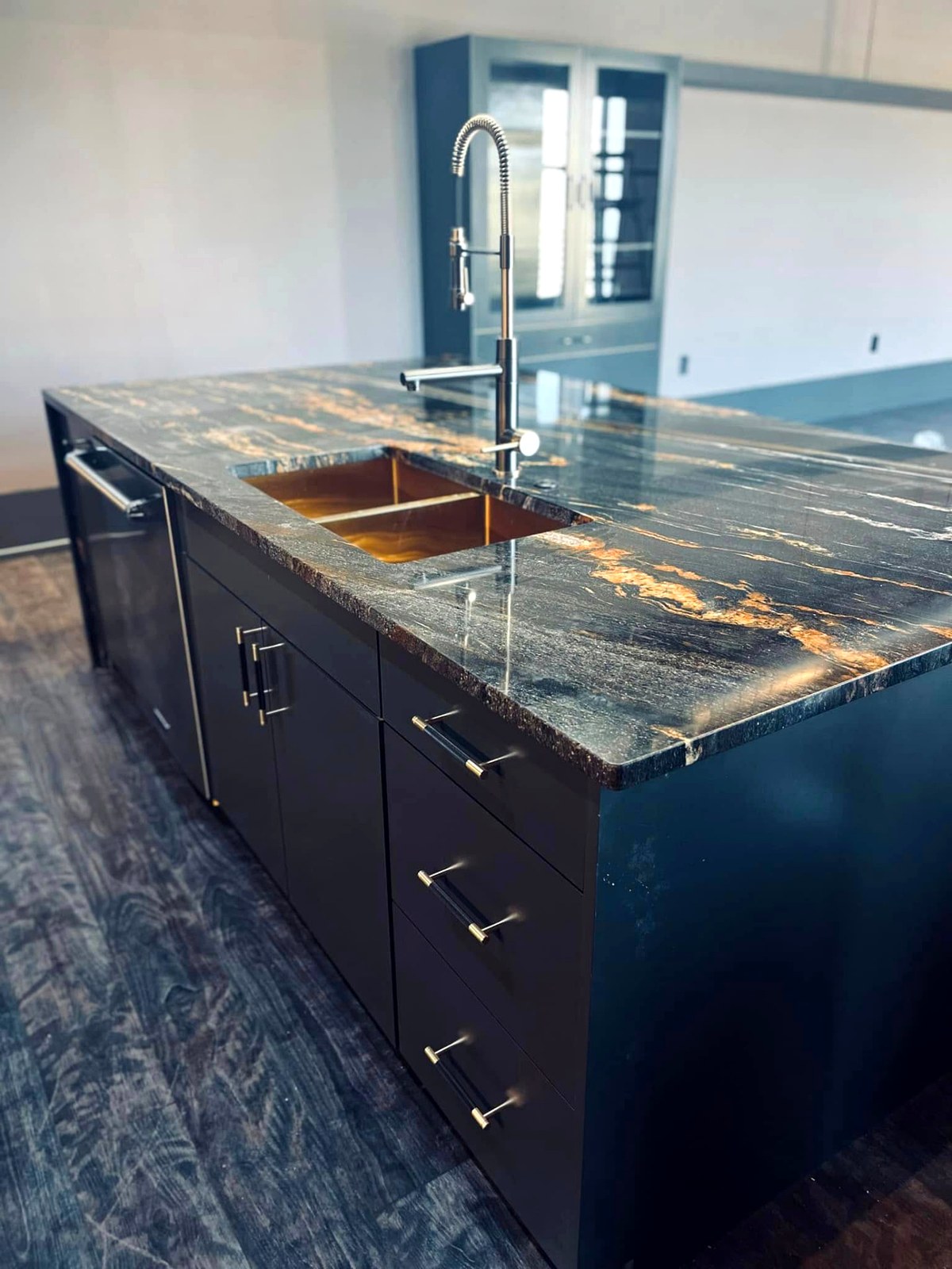 Matte black kitchen island with leathered granite top