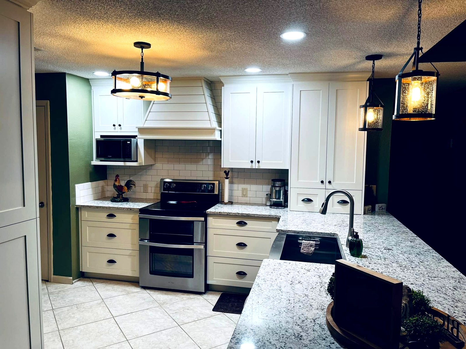 White farmhouse kitchen cabinets with shiplap hood and subway tile